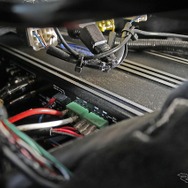 大型アンプであるARC1000.6は運転席下のスペースを使って前後方向に縦置きされている。
