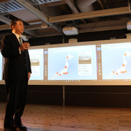 ICT・IoTを活用した教育環境例のデモンストレーションを行う大久保氏。IoTを搭載した百葉箱のデータ活用授業の一場面を再現